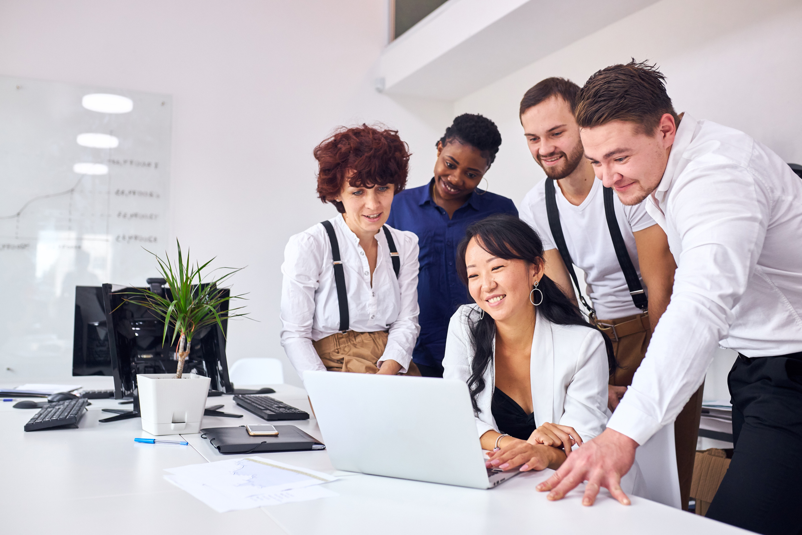 Five people gathered around laptop